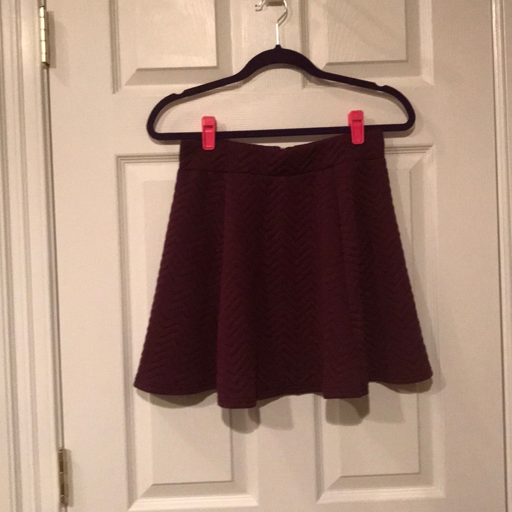 Purple skirt with silver zipper in back.